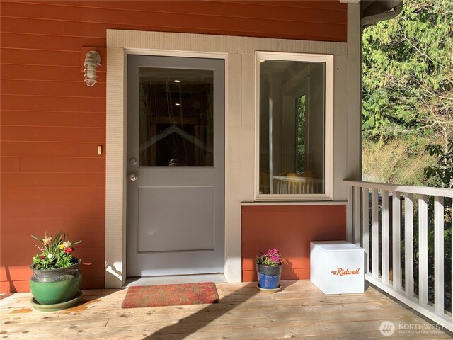 doorway to property featuring brick siding