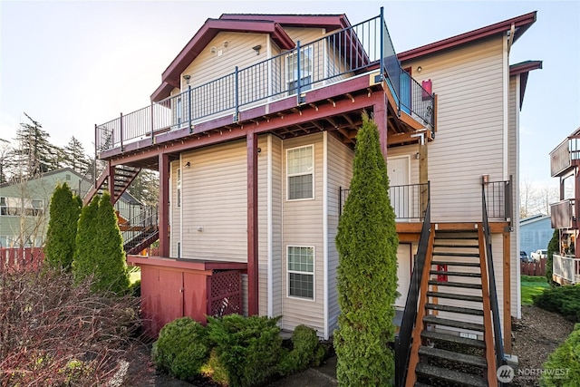 back of house featuring stairs