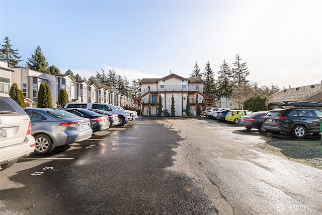 uncovered parking lot featuring a residential view