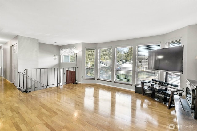 living room with baseboards and wood finished floors