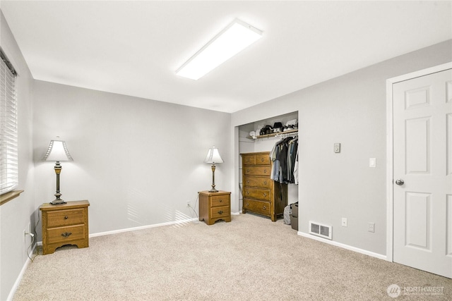 carpeted bedroom featuring baseboards, visible vents, and a closet