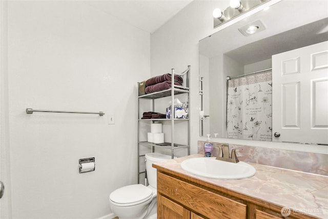 bathroom featuring toilet, a shower with shower curtain, and vanity