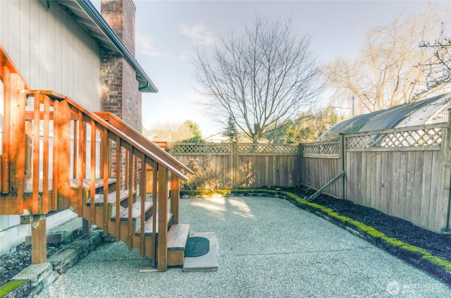 view of patio / terrace with a fenced backyard and stairs