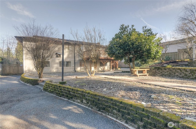 view of front of house featuring fence