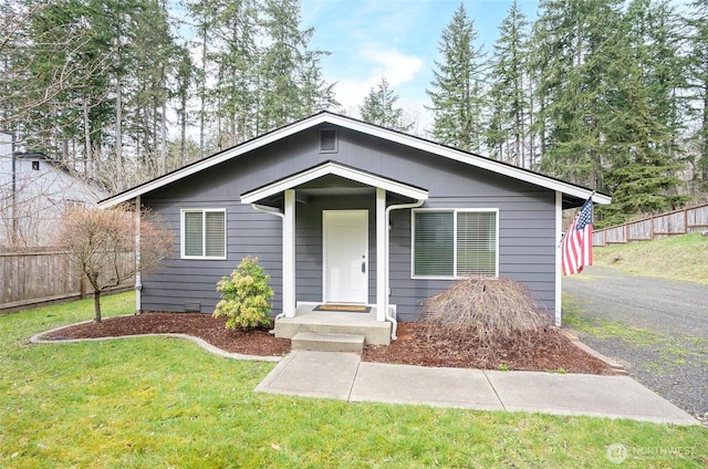 bungalow-style house featuring crawl space, a front yard, and fence