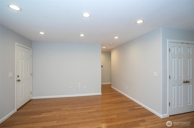 unfurnished room featuring recessed lighting, baseboards, and light wood finished floors