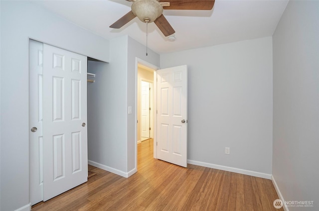 unfurnished bedroom with a closet, baseboards, light wood-style floors, and a ceiling fan