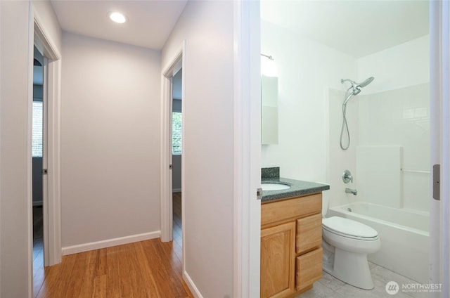 bathroom featuring shower / bathing tub combination, toilet, a healthy amount of sunlight, and vanity