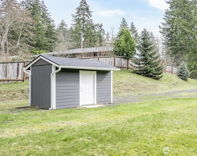 view of shed featuring fence