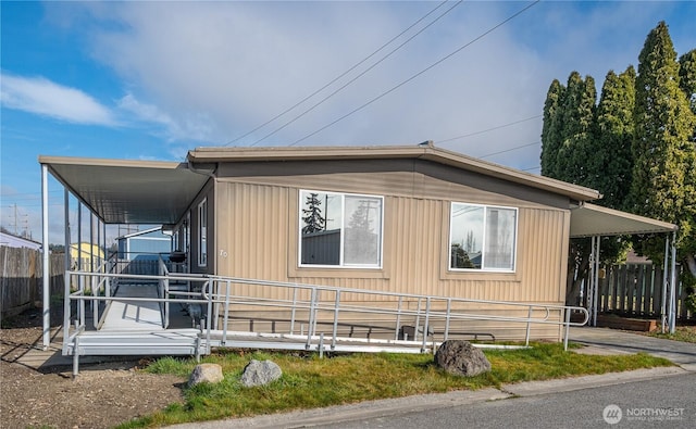 view of side of property featuring a carport