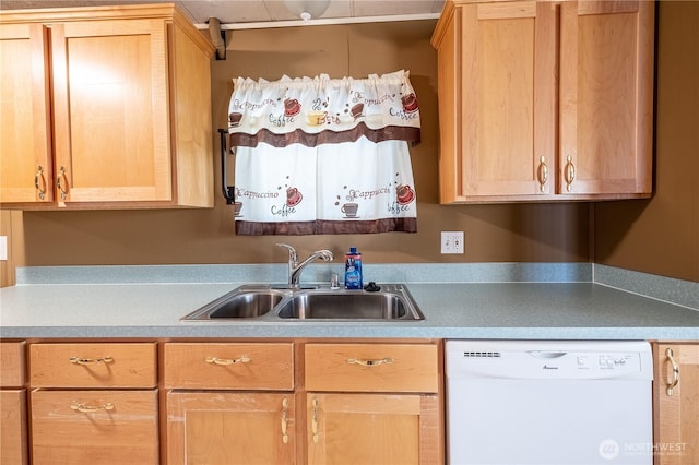 kitchen with light brown cabinets, light countertops, white dishwasher, and a sink