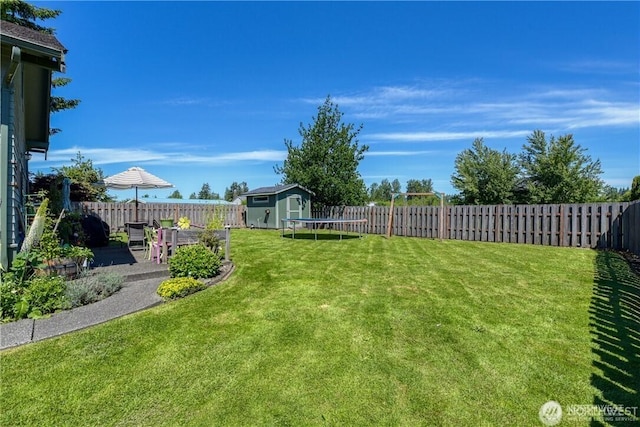 view of yard featuring a fenced backyard, an outdoor structure, a patio, and a shed