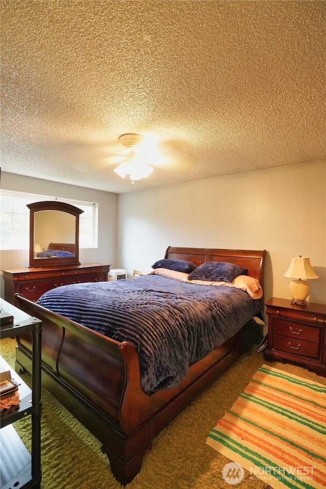 carpeted bedroom featuring a textured ceiling