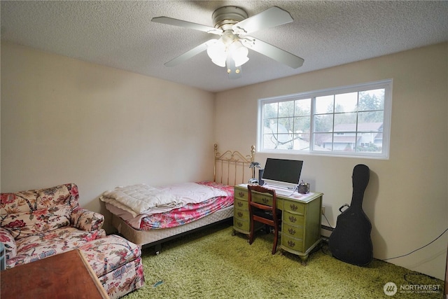 carpeted bedroom with a ceiling fan, a baseboard heating unit, and a textured ceiling