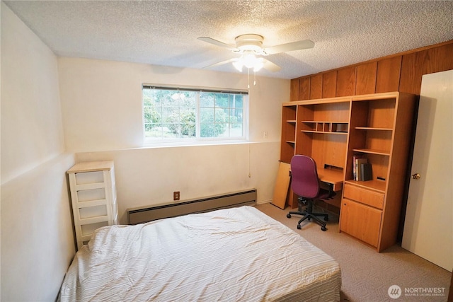 bedroom featuring a ceiling fan, light carpet, a textured ceiling, and baseboard heating