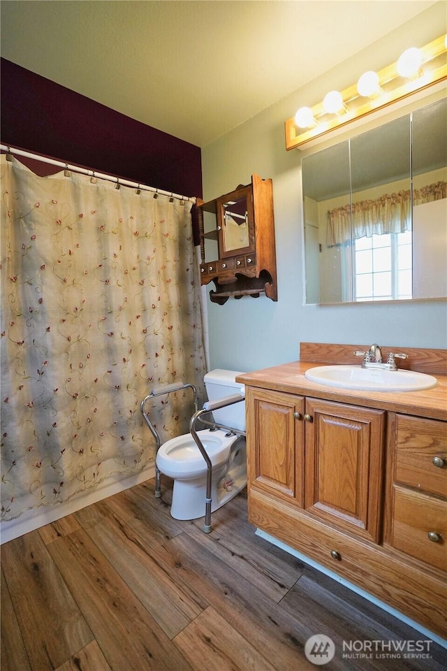 full bathroom with toilet, wood finished floors, vanity, and a shower with curtain