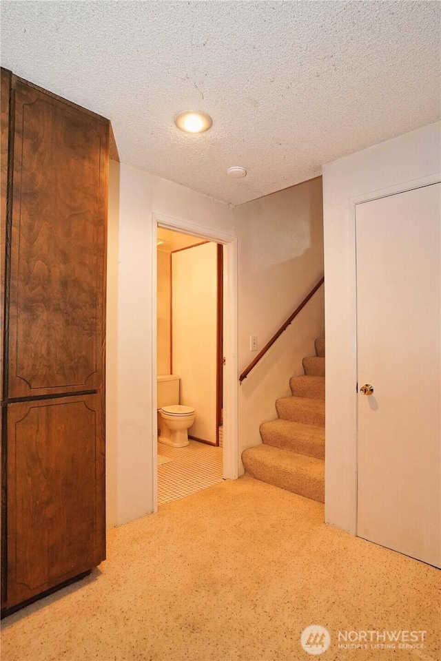 interior space with a textured ceiling and carpet