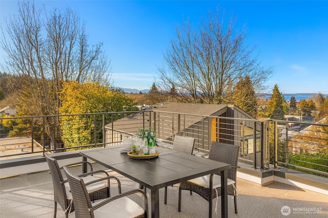 view of patio with a balcony and outdoor dining area