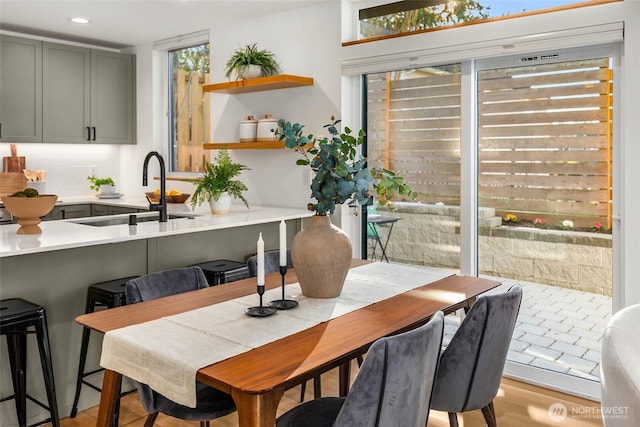 dining room with recessed lighting and light wood-style flooring