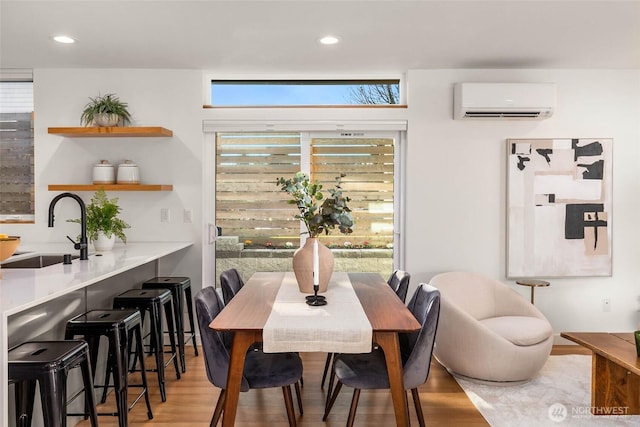 dining space featuring recessed lighting, wood finished floors, and a wall mounted AC