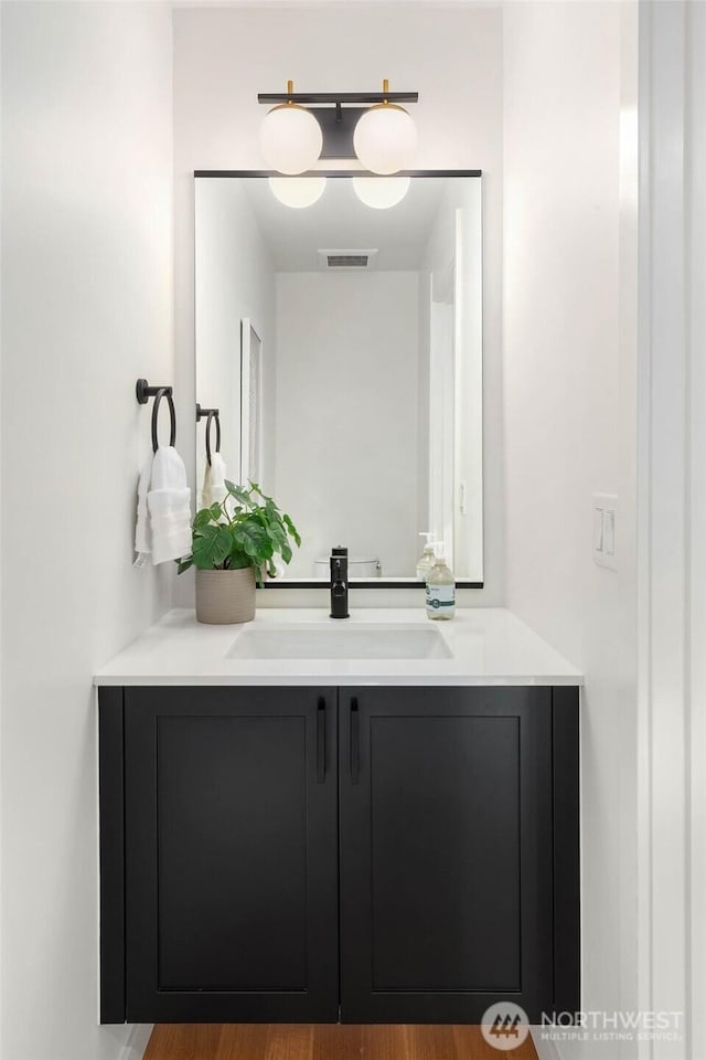 bathroom featuring visible vents and vanity