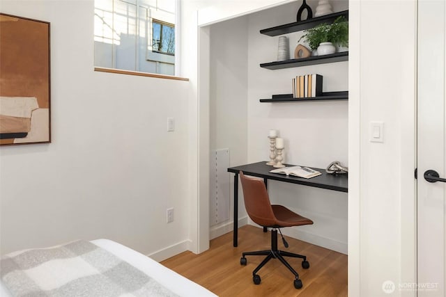 bedroom featuring wood finished floors and baseboards