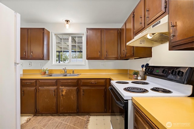 kitchen featuring under cabinet range hood, light floors, light countertops, range with electric stovetop, and a sink