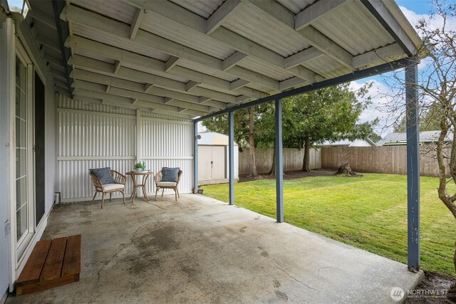 view of patio / terrace featuring a fenced backyard, a storage shed, and an outdoor structure