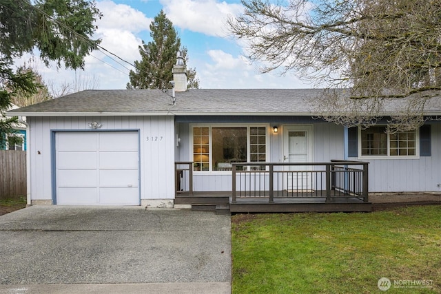 ranch-style house featuring a front lawn, covered porch, roof with shingles, an attached garage, and a chimney