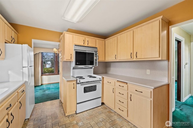 kitchen featuring white appliances, light brown cabinets, and light countertops