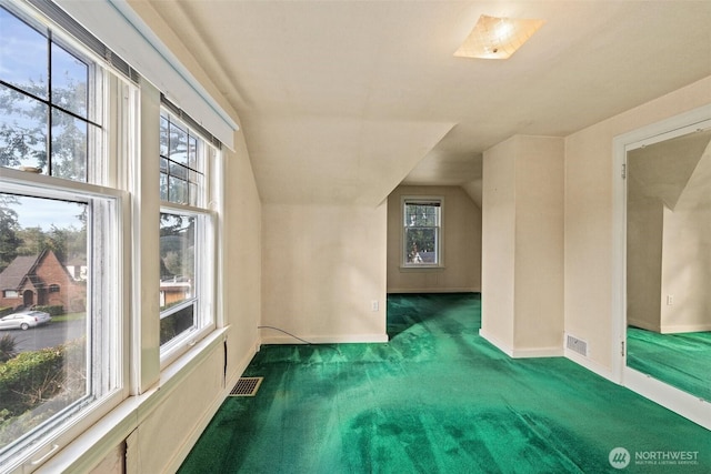 bonus room featuring visible vents, carpet flooring, baseboards, and lofted ceiling