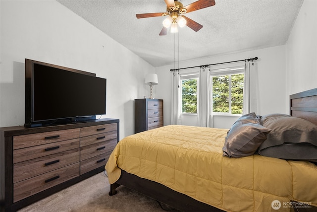 bedroom featuring a textured ceiling, carpet flooring, a ceiling fan, and lofted ceiling