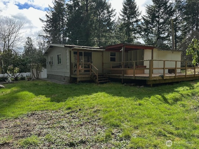 rear view of house with a yard, crawl space, and a wooden deck