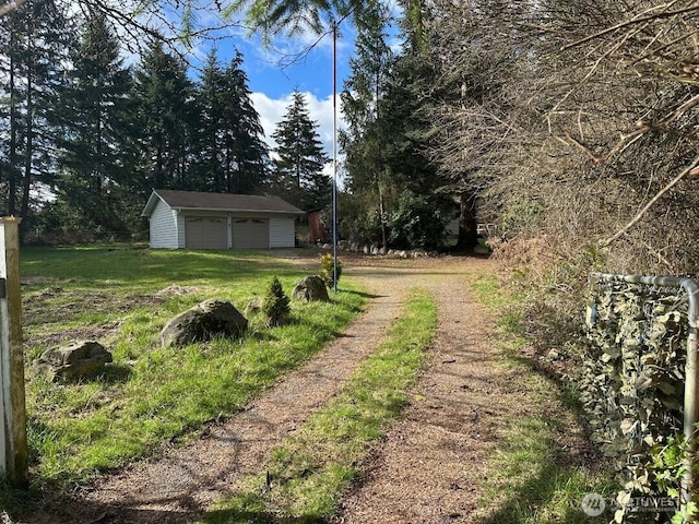 view of yard with an outbuilding and a detached garage