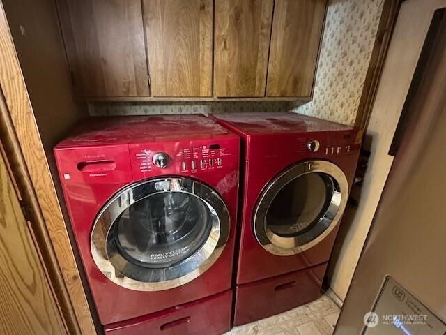 laundry area featuring washer and dryer and cabinet space