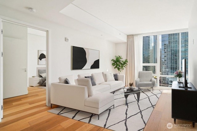 living room featuring wood finished floors and floor to ceiling windows