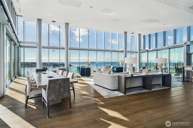 interior space featuring hardwood / wood-style floors, a water view, and expansive windows