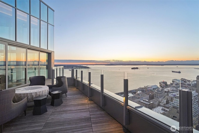 wooden deck featuring a water view