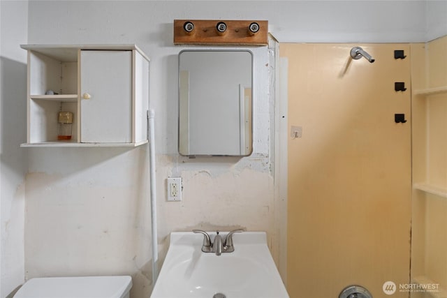 half bath with toilet and a sink