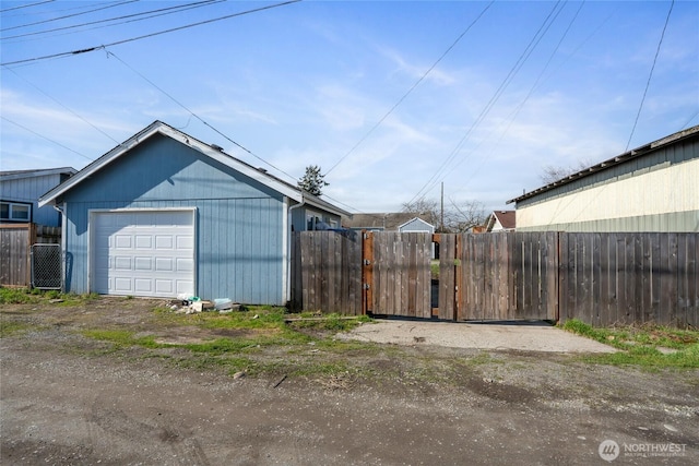 detached garage featuring a gate and fence