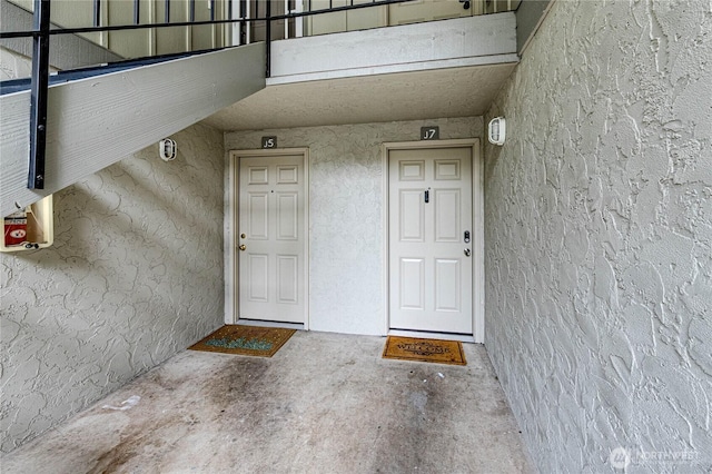 view of exterior entry featuring stucco siding