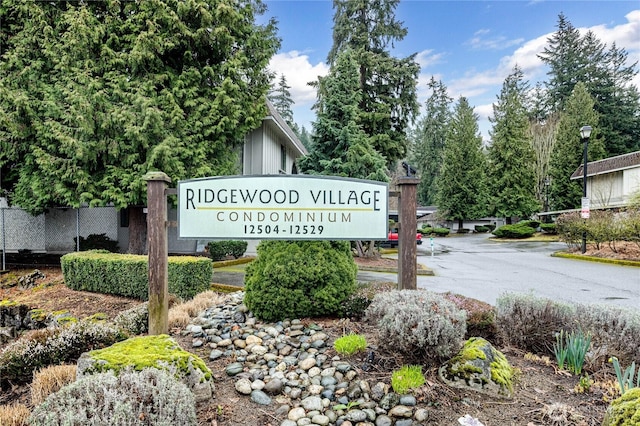 community / neighborhood sign with fence