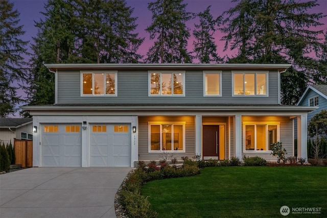 traditional-style house featuring concrete driveway, a front lawn, and an attached garage