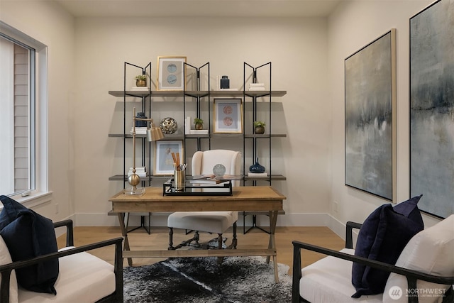 office space with baseboards and wood finished floors