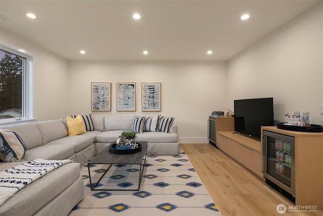 living room featuring beverage cooler, recessed lighting, and light wood-style floors