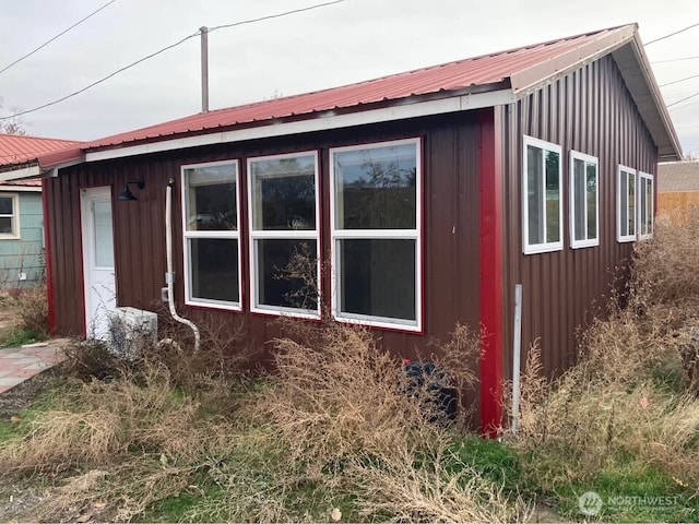 view of side of home with board and batten siding and metal roof