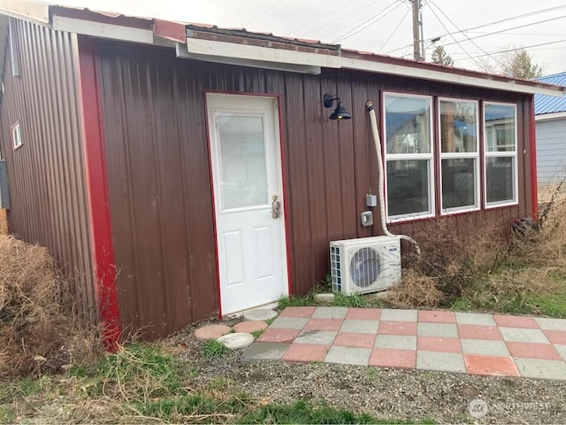 view of exterior entry with ac unit