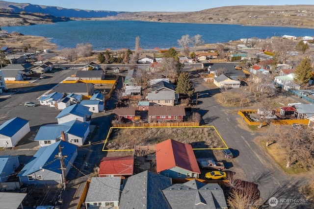 drone / aerial view with a residential view and a water and mountain view