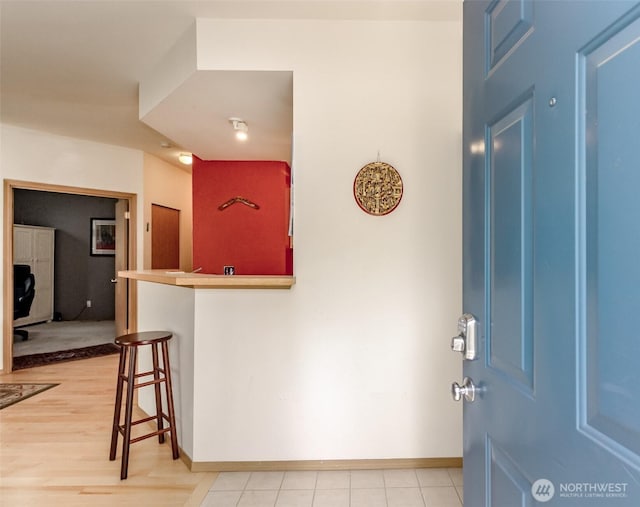 entrance foyer featuring light wood-style floors and baseboards