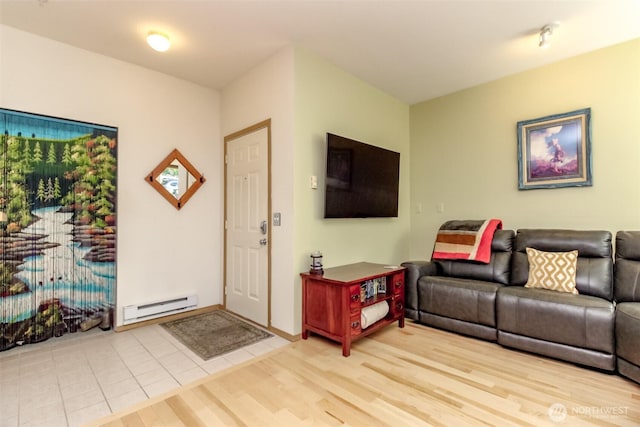 living area with a baseboard heating unit and wood finished floors